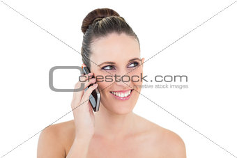 Smiling woman on the phone looking away