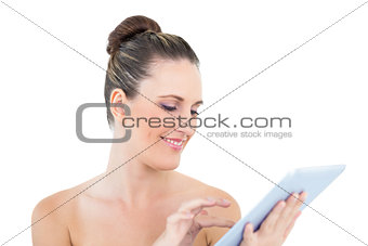 Smiling woman scrolling on her tablet