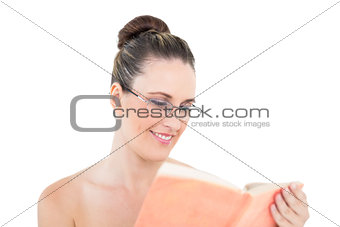 Young woman wearing glasses and reading book