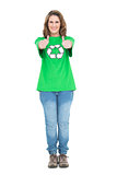 Woman wearing green tshirt with recycling symbol giving thumbs up