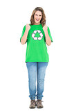 Happy young woman wearing  green shirt with recycling symbol