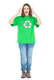 Woman wearing green shirt with recycling symbol screaming