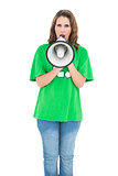 Attractive environmental activist screaming in a megaphone