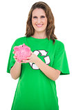 Smiling environmental activist showing piggy bank