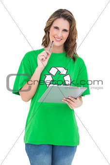 Smiling environmental activist holding clipboard looking at camera