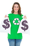 Smiling environmental activist holding money bags