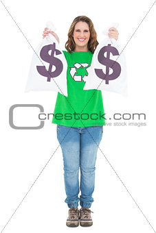 Smiling environmental activist holding money bags looking at camera