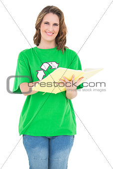 Smiling environmental activist holding notebook looking at camera