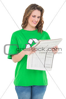 Smiling environmental activist reading newspaper