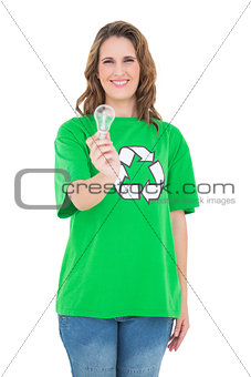 Smiling environmental activist holding light bulb