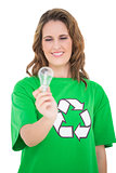Close up on environmental activist holding light bulb