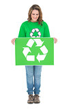 Happy environmental activist holding recycling sign