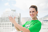 Happy environmental activist holding glass pots
