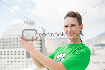 Happy environmental activist holding glass pots