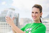 Smiling environmental activist holding glass pots