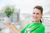 Smiling activist holding plant