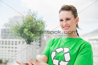 Happy activist holding plant