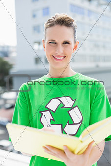 Smiling pretty environmental activist writing