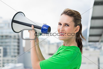 Smiling woman holding megaphone