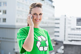 Cheerful woman wearing recycling tshirt having a call