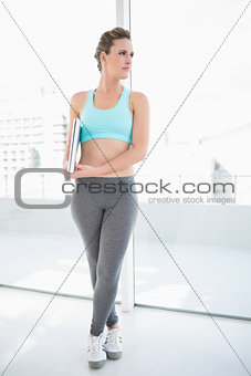 Woman wearing sportswear holding laptop