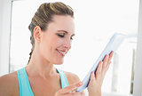 Close up view on smiling woman holding tablet