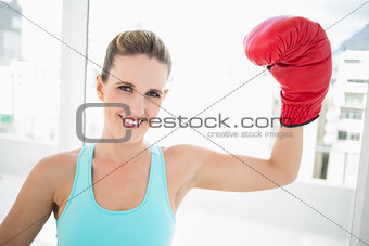 Woman rising her boxing glove up