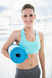 Young woman holding her fitness mat