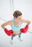 Fit woman with boxing gloves posing