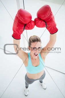 Woman with red boxing gloves arms up