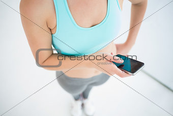Woman in sportswear using her smartphone
