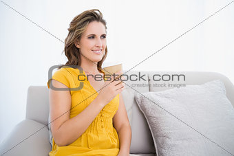 Thoughtful woman sitting on couch