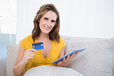 Pretty woman using her credit card to buy online