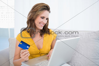 Pretty blonde using her credit card to buy online
