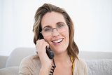 Close up view of woman wearing glasses talking on the telephone