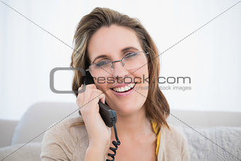 Close up view of woman wearing glasses talking on the telephone