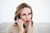 Shocked woman talking on the telephone