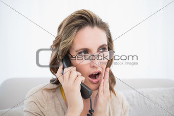 Shocked woman talking on the telephone