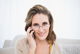 Smiling woman with glasses talking on the phone