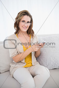 Cheerful attractive woman using phone