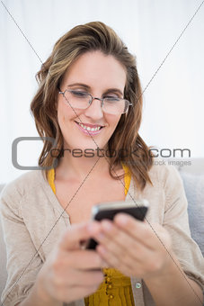 Smiling attractive woman wearing glasses using phone