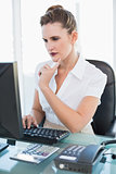 Thoughtful businesswoman working on computer