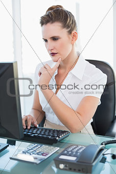 Thoughtful businesswoman working on computer