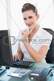 Smiling businesswoman working on computer
