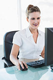 Happy businesswoman looking at her computer screen