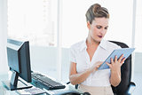 Focused businesswoman using her digital tablet