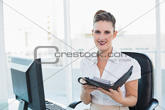 Smiling woman holding her datebook