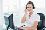 Happy call centre agent sitting on swivel chair