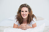 Portait of smiling woman lying on bed