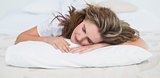 Woman sleeping in cosy bed
